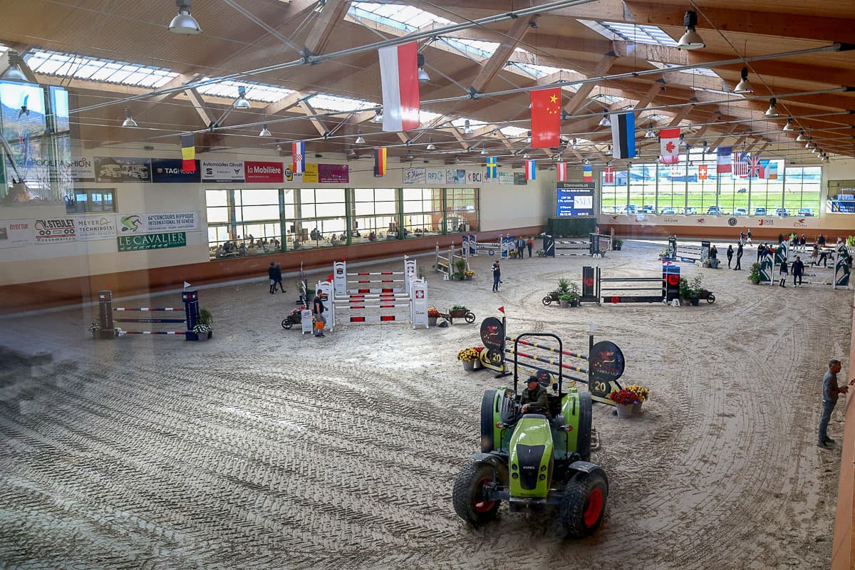 Grooming the arena footing between classes