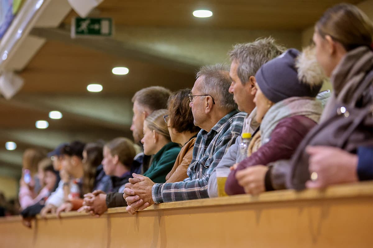 Spectators at the arena rail