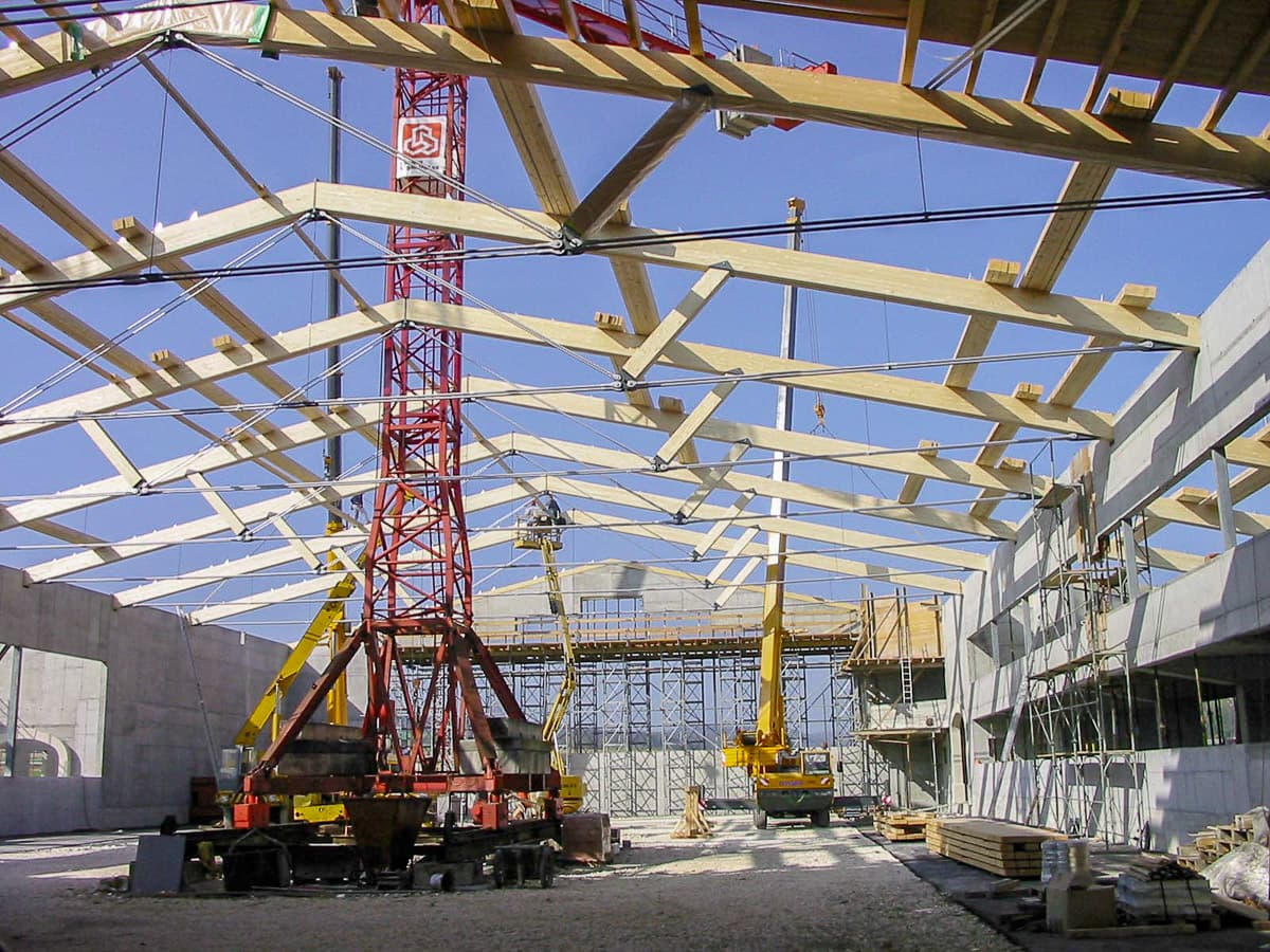 The indoor hall's roof trusses going up