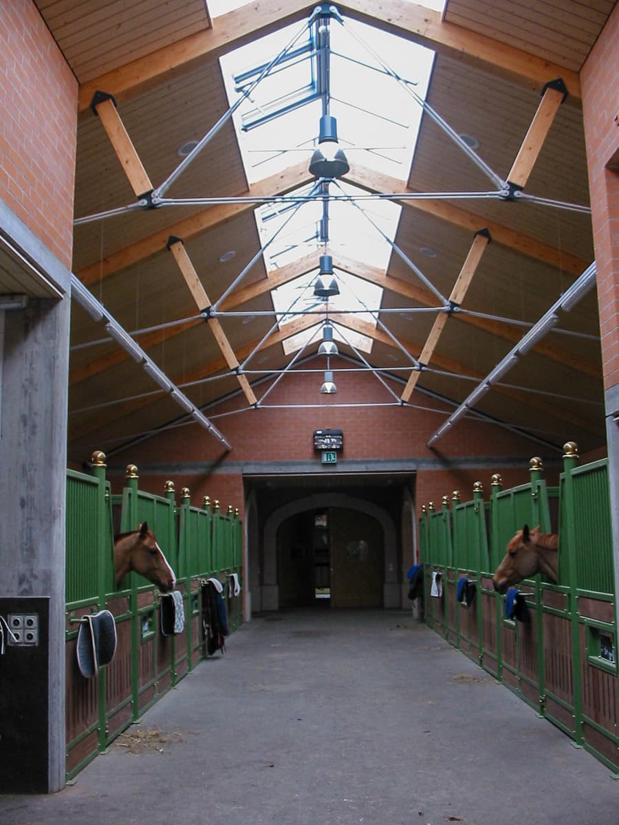 The stable aisle under its skylight