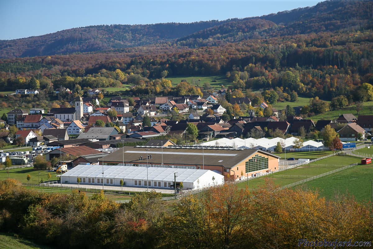 Ecurie Chevenez and the village of Chevenez seen from the hillside in autumn