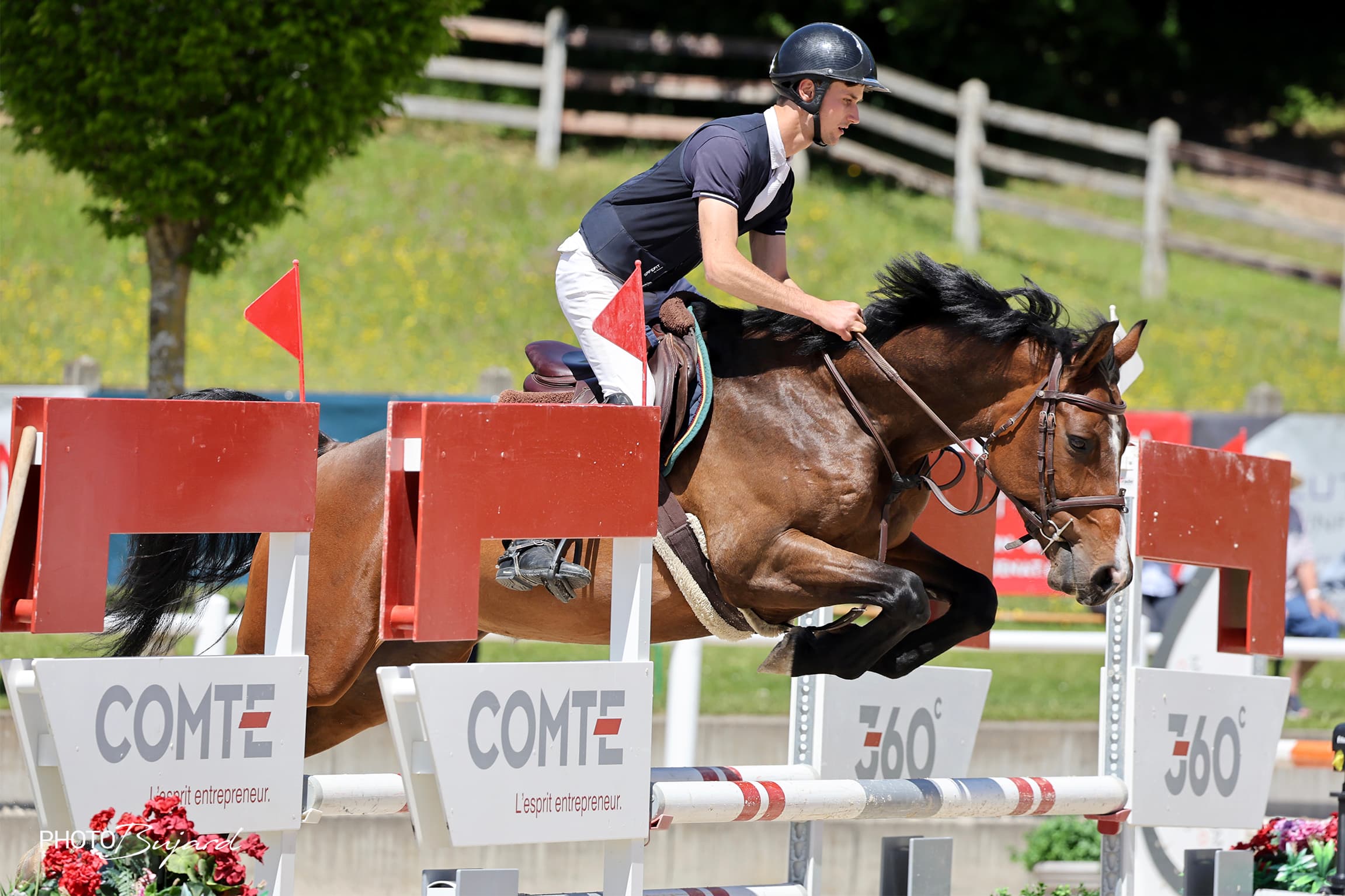 A Chevenez horse and rider clearing an oxer in competition